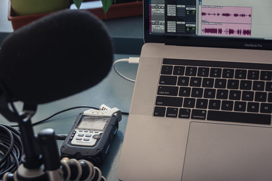 A podcast microphone on a home studio desk
