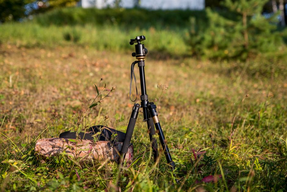 Flexible tripod holding a camera wrapped around a rail