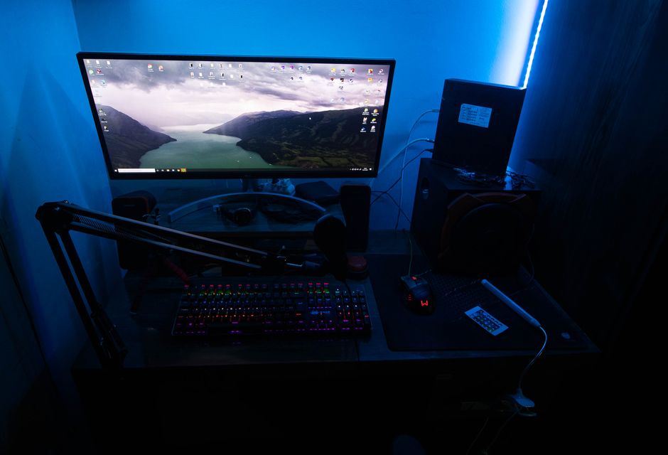 Streaming webcam mounted above a monitor in a creator setup